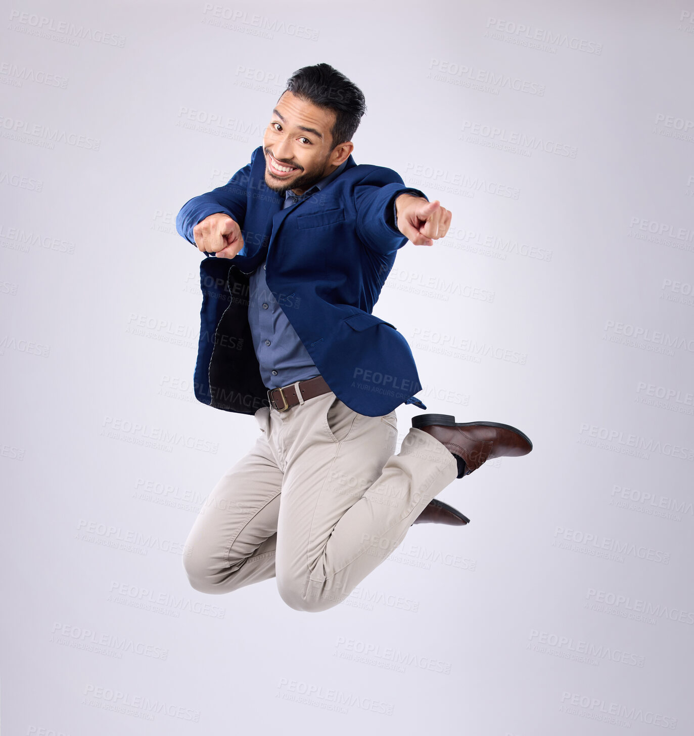 Buy stock photo Jump, excited and portrait of man point in studio with surprise, happiness and celebration on white background. Winner, success mockup and isolated happy male jumping with energy, smile and victory