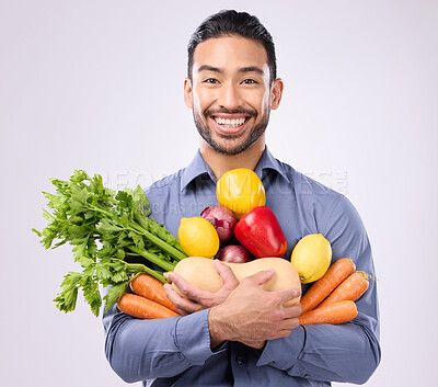 Buy stock photo Healthy, happy and portrait of an Asian man with vegetables isolated on a white background in a studio. Smile, holding and a Japanese male with food for a diet, vegan lifestyle and nutrition