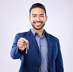 Realtor man, keys and studio portrait with smile, dream and excited face for new home, property and background. Happy asian businessman, real estate agent and entrepreneur for buying of buildings