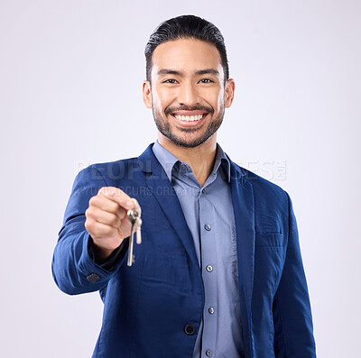 Buy stock photo Realtor man, keys and studio portrait with smile, dream and excited face for new home, house or property on background. Happy asian businessman and real estate agent for professional buying