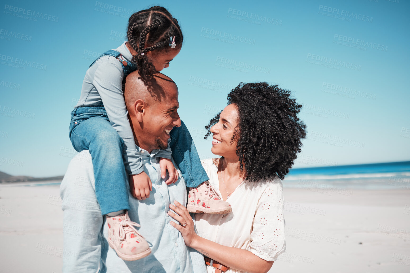 Buy stock photo Happy, love and family at the beach while on a vacation, adventure or summer weekend trip. Happiness, smile and girl child by the ocean with her parents while on a tropical seaside holiday in Mexico.