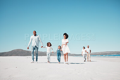 Buy stock photo Holding hands, family and children walking on beach to relax on summer holiday, vacation and weekend. Travel, blue sky and grandparents, parents and kids by ocean for fun, bonding and quality time