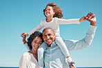 Family, smile and piggyback portrait on blue sky at beach on vacation, bonding and care at seashore. Holiday relax, summer and happy father, mother and kid or girl enjoying playing together outdoors.