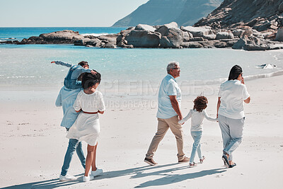 Buy stock photo Grandparents, parents and children on beach walking to relax on summer holiday, vacation and weekend. Nature, travel and back of big family holding hands for bonding, quality time and calm by ocean