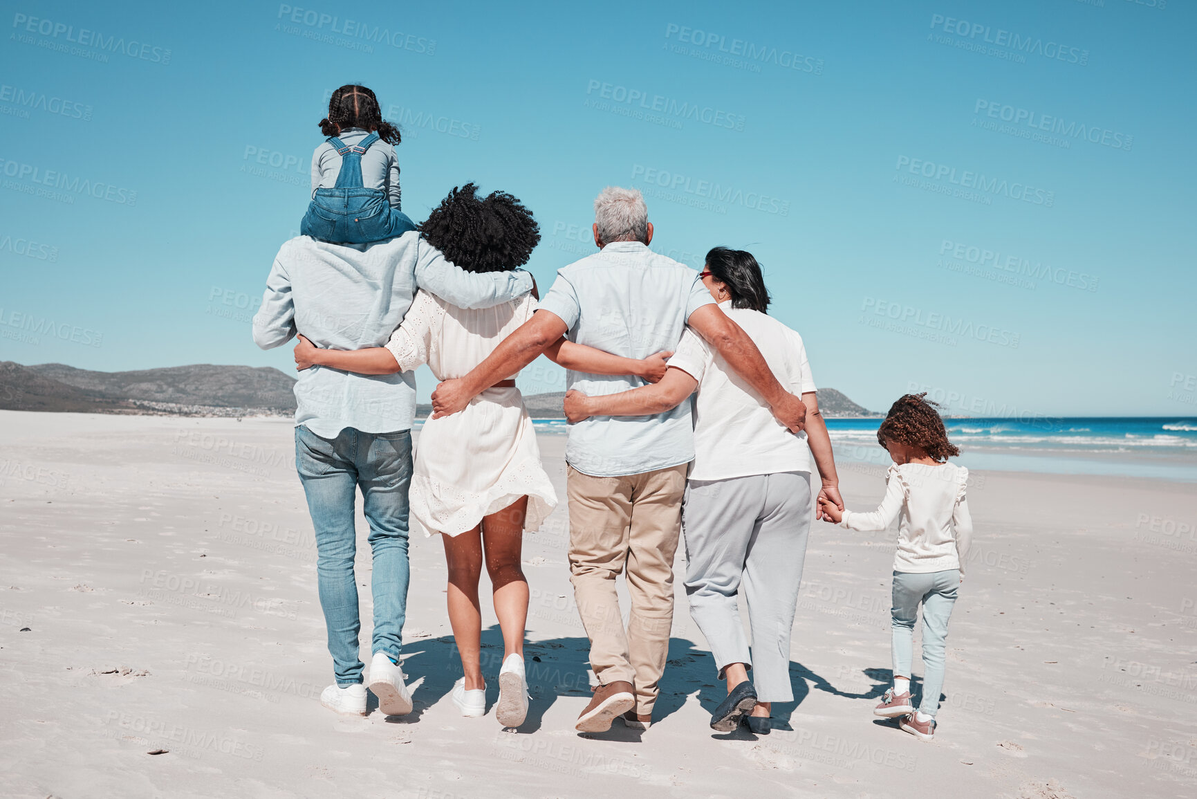 Buy stock photo Back of family on beach walking with children to relax on summer holiday, vacation and weekend together. Travel mockup, ocean and grandparents, parents and kids hug for bonding, quality time and calm