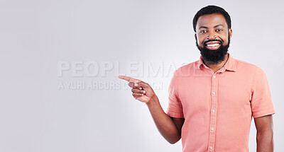 Buy stock photo Point, mockup space and portrait of black man with hand gesture for product placement, advertising and sign. Happy, studio and male smile on white background pointing for choice, branding and showing