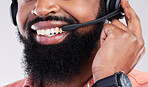 Closeup, consultant and black man with headset, telemarketing and explain process against a studio background. Zoom, male employee and happy agent with headphones, customer service and tech support