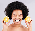 Skincare, portrait and orange by black woman in studio for vitamin c, wellness or skin detox on grey background. Face, fruit and girl model excited for citrus treatment, cosmetics or beauty routine