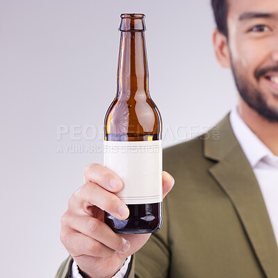 Buy stock photo Man face with beer bottle isolated on a white background for alcohol product promotion drink, happy hour and cheers. Professional Asian person or model hand holding wine glass container in studio