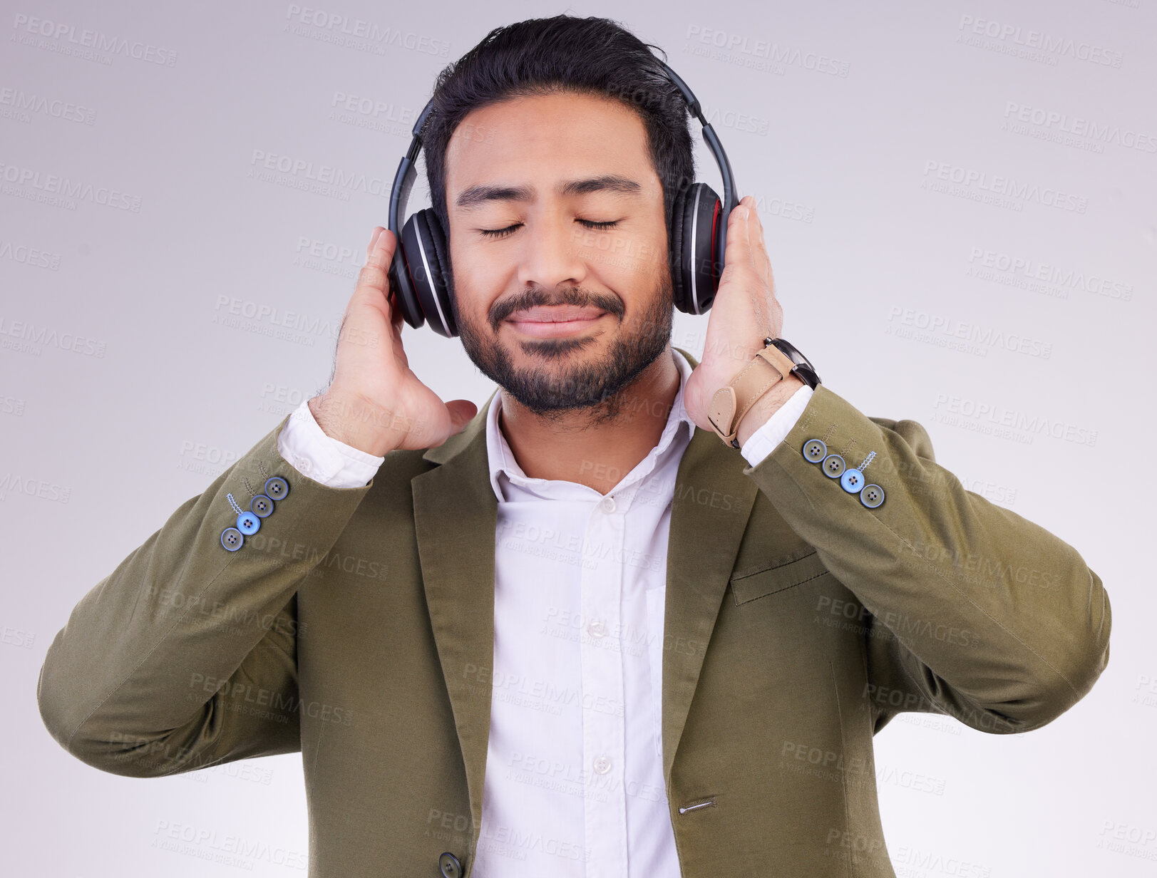 Buy stock photo Music, relax and headphones with a business man in studio on a gray background streaming audio. Peace, quiet and calm with a male employee listening to the radio during a mental health break