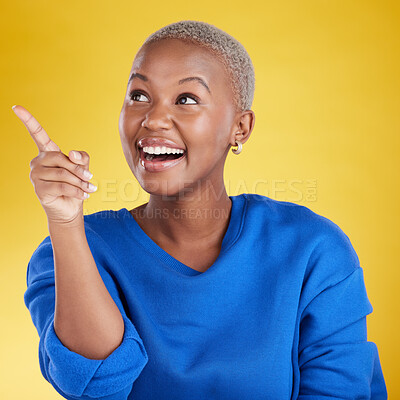 Buy stock photo Smile, pointing to mockup and black woman in studio isolated on a yellow background. Thinking, happy and African female model point to advertising, marketing or product placement for branding space.