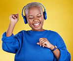 Music, headphones and black woman dance in studio isolated on a yellow background. Podcast, radio and happy African female streaming, enjoying and listening to audio, sound track or song for dancing.