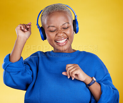 Buy stock photo Music, headphones and black woman dance in studio isolated on a yellow background. Podcast, radio and happy African female streaming, enjoying and listening to audio, sound track or song for dancing.