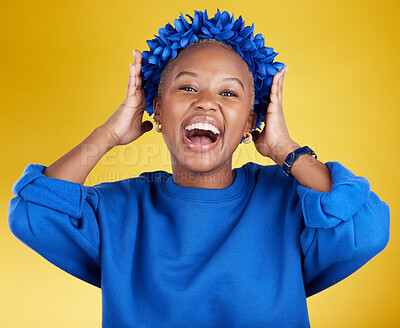 Buy stock photo Portrait, queen and flower crown with an excited black woman in studio on a yellow background. Face, expression and sustainability with an attractive female wearing a blue wreath as royalty