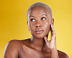 Beauty, skincare and serious with black woman in studio for cosmetics, satisfaction and self care. Glow, dermatology and confidence with female model on yellow background for natural and treatment 