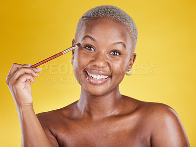 Buy stock photo Beauty, cosmetics and portrait of black woman with brush in hand in studio and skincare isolated on yellow background. Happy makeup routine, eye shadow and smile, face of model with luxury product.