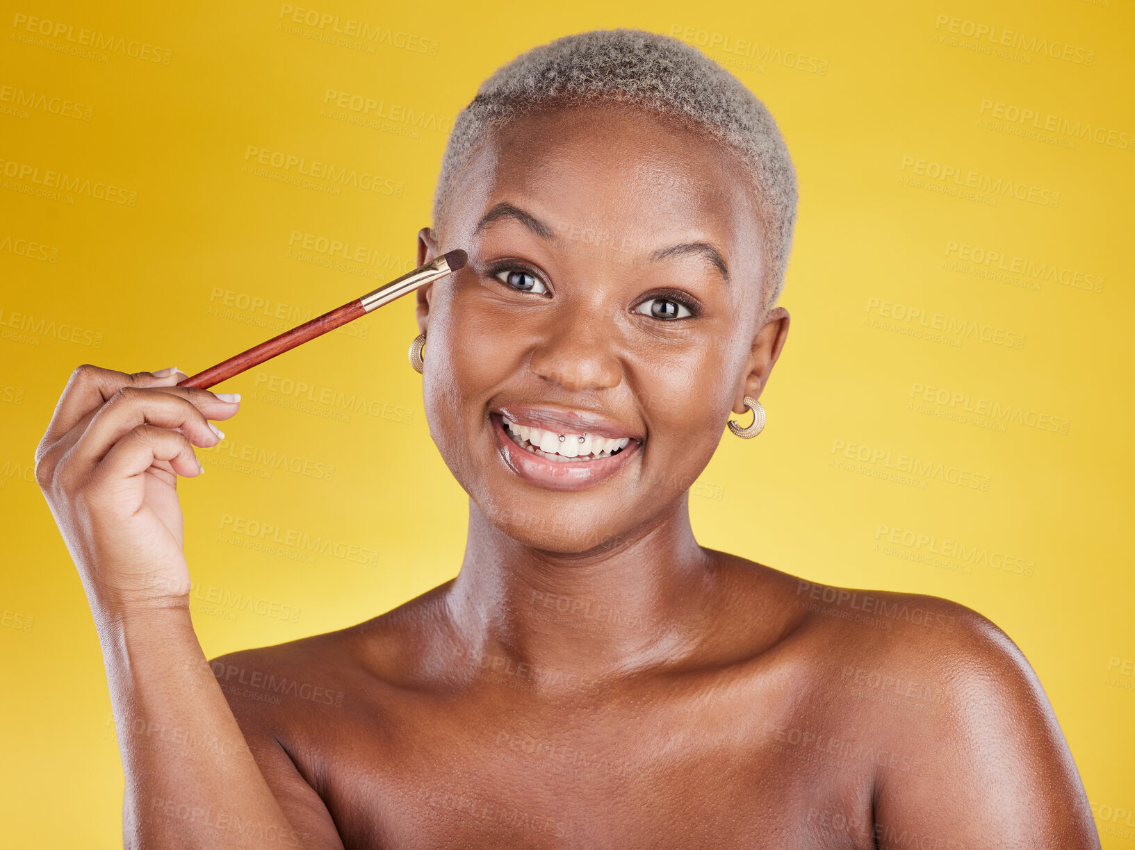 Buy stock photo Beauty, cosmetics and portrait of black woman with brush in hand in studio and skincare isolated on yellow background. Happy makeup routine, eye shadow and smile, face of model with luxury product.