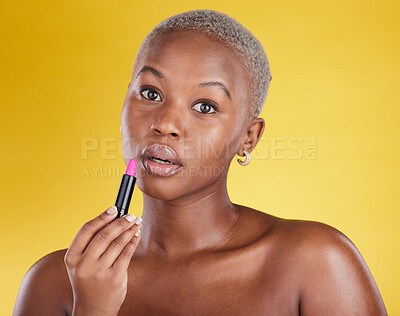 Buy stock photo Face portrait, makeup and black woman with lipstick in studio isolated on a yellow background. Cosmetics, beauty and African female model with lip gloss product for aesthetics, wellness and skincare.