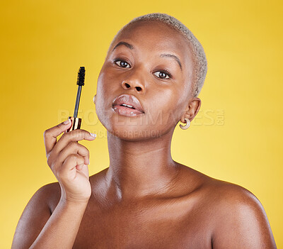 Buy stock photo Beauty, cosmetics and portrait of black woman with mascara brush in hand in studio isolated on yellow background. Makeup routine, lashes and skincare, face of gen z African model with luxury product.