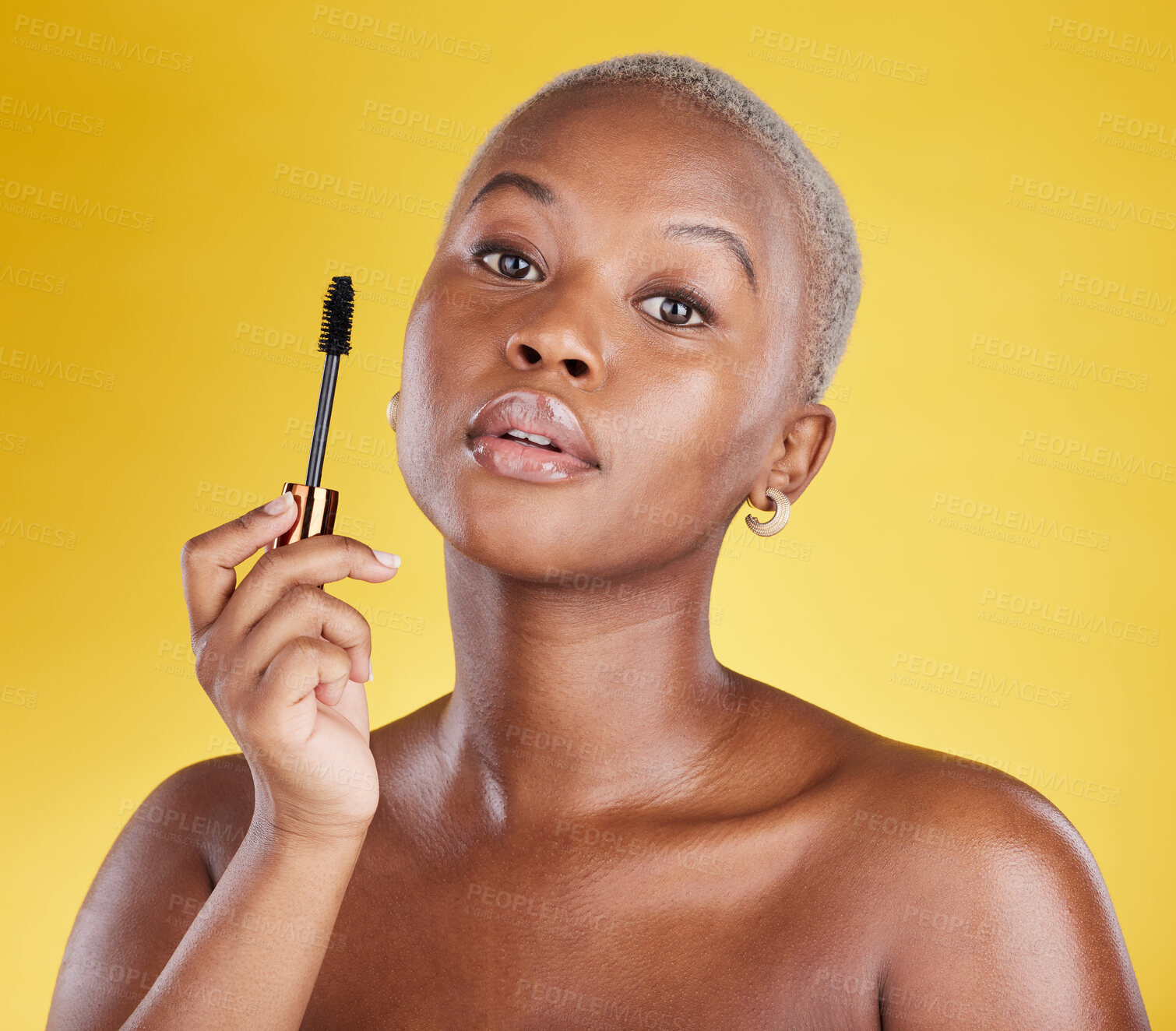 Buy stock photo Beauty, cosmetics and portrait of black woman with mascara brush in hand in studio isolated on yellow background. Makeup routine, lashes and skincare, face of gen z African model with luxury product.