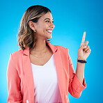 Smile, mock up and Indian woman in studio pointing up for product placement, mockup or information. Deal, promotion or announcement, happy model showing info space or notification on blue background.