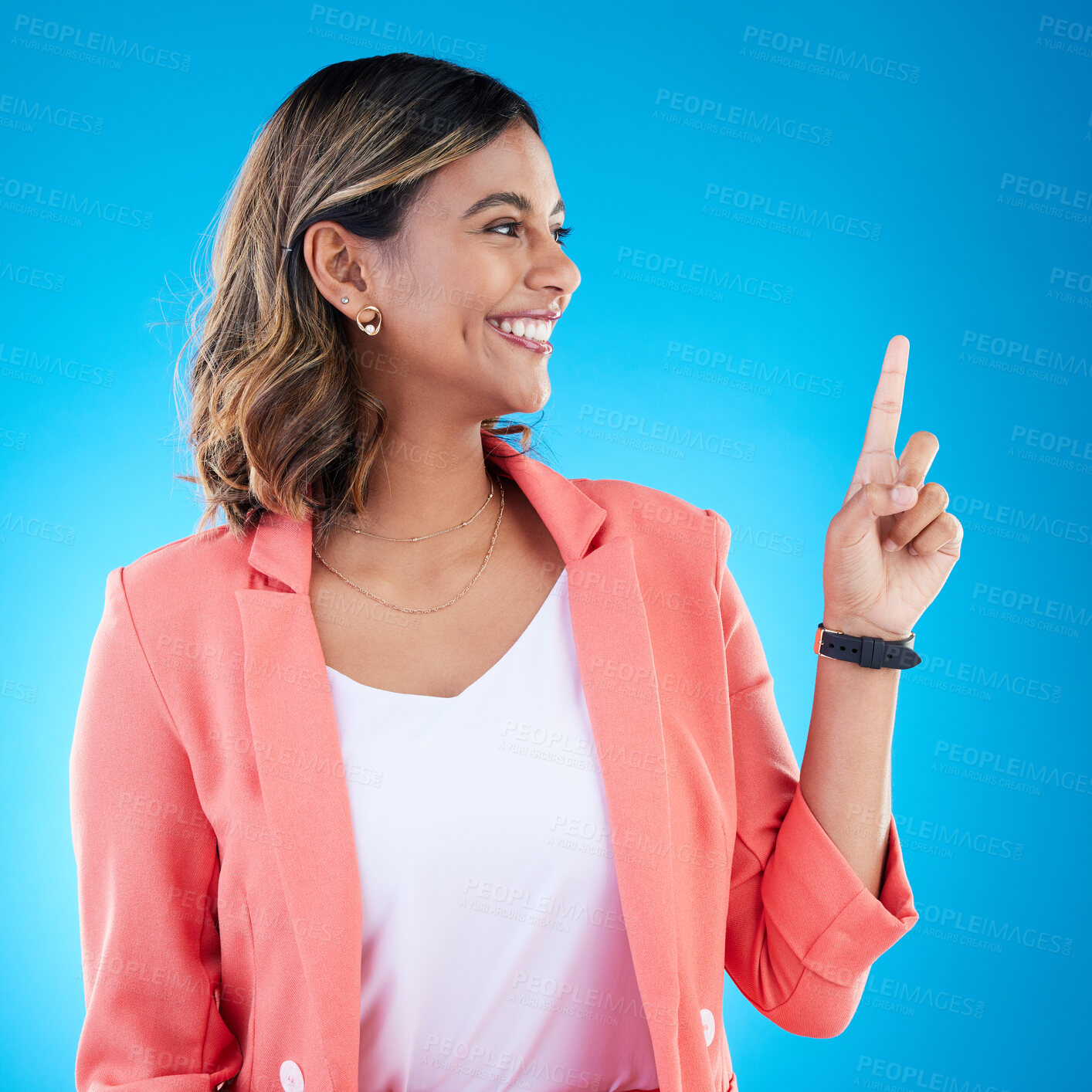 Buy stock photo Smile, mock up and Indian woman in studio pointing up for product placement, mockup or information. Deal, promotion or announcement, happy model showing info space or notification on blue background.