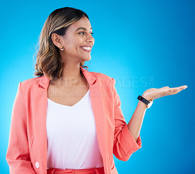 Buy stock photo Smile, mockup and business woman with product placement in studio isolated on a blue background. Mock up, promotion and happy Indian female with palm for advertising, marketing or branding space.