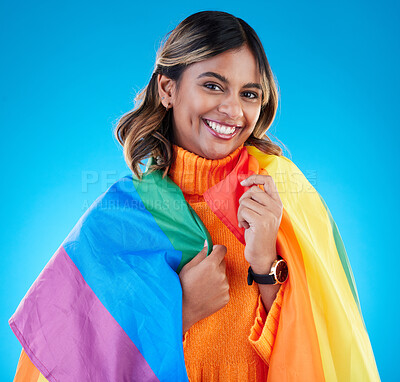 Buy stock photo Portrait, pride flag and woman with smile, support and queer against a blue studio background. Face, happy female and lady with equality, symbol for lgbtq community and transgender with human rights