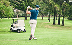 Golf, stroke and grass with a sports man swinging a club on a field or course for recreation and fun. Golfing, hobby and training with a male golfer playing a game on a course during summer