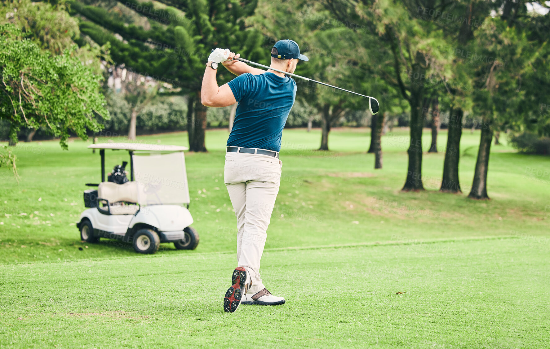 Buy stock photo Golf, stroke and grass with a sports man swinging a club on a field or course for recreation and fun. Golfing, hobby and training with a male golfer playing a game on a green during summer
