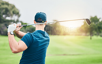 Golf, stroke and back with a sports man swinging a club on a field or course for recreation and fun. Golfing, grass and training with a male golfer playing a game on a course during summer