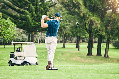 Buy stock photo Golf, stroke and focus with a sports man swinging a club on a field or course for recreation and fun. Golfing, grass and training with a male golfer playing a game on a green during summer