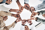 Team building, circle or happy business people fist bump for motivation in office meeting together. Diversity, low angle or employees with mission, strategy or group support for  project planning