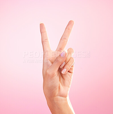 Buy stock photo Woman, hands and peace sign, emoji or symbol for freedom against a pink studio background. Hand of female showing peaceful V icon or shape for hope, support or trust in vote or voice on mockup