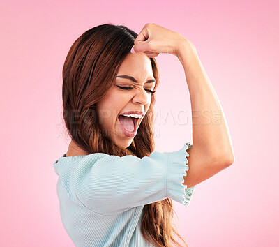 Buy stock photo Strong, proud and female flexing in a studio for feminism, women empowerment and body positivity. Happiness, excited and young woman model posing to show her arm strength isolated by pink background.