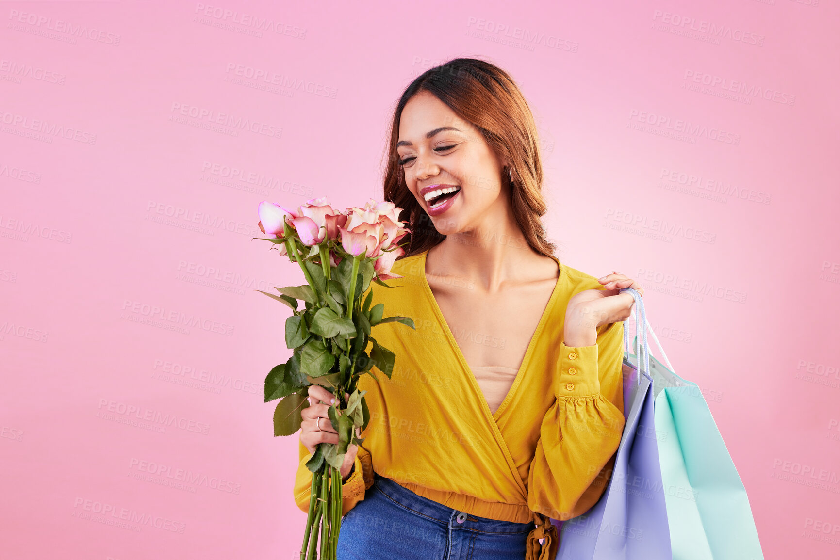 Buy stock photo Happy, shopping bags and smile with woman and flowers in studio for retail, birthday and spring. Event, party and celebration with female and roses on pink background for sale, discount and romance