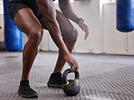 Kettlebell, hands and legs of man training for weightlifting, fitness workout and sports challenge in gym. Closeup bodybuilder holding heavy weights for exercise, power and muscle of strong athlete 