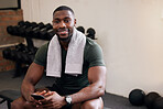 Gym, phone and portrait of happy man rest to check social media, search internet and workout progress app. Black male, sports break and mobile technology for fitness, smile and bodybuilder training