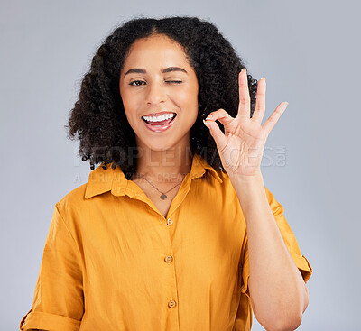 Buy stock photo Perfect, happy and portrait of a winking woman isolated on a white background in a studio. Smile, review and girl with a hand gesture for satisfaction, happiness and okay emoji icon on a backdrop