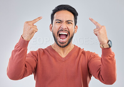 Buy stock photo Angry, middle finger and portrait of asian man in studio for rude, conflict and problem. Annoyed, upset and aggressive with male and hand gesture on gray background for hate, disrespect and furious