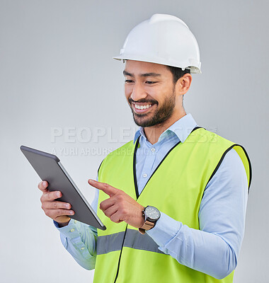 Buy stock photo Construction worker, engineer and happy man in studio with tablet and helmet safety on white background. Smile, internet and contractor or architect in online planning for project management in India