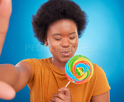 Buy stock photo Woman, rainbow lollipop and selfie in studio with a smile and happiness or lgbtq pride on face. Black female model with a color candy on a blue background with sugar, sweets or dessert while excited