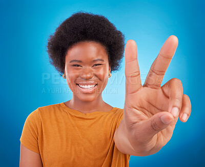Buy stock photo Peace sign closeup, black woman hand and portrait of a model with a smile and happiness. Isolated, blue background and v hands gesture of a young female with a afro and beauty feeling excited