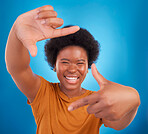Finger framing, portrait and happy black woman on blue background, studio and backdrop. Face, female and hands frame perspective, selfie and smile of happiness, photography or capture profile picture