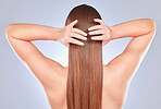 Hair touch, woman and back of a model with beauty, wellness and soft hairstyle texture in a studio. Cosmetics, shampoo treatment and keratin of a female with healthy, clean and haircare aesthetic
