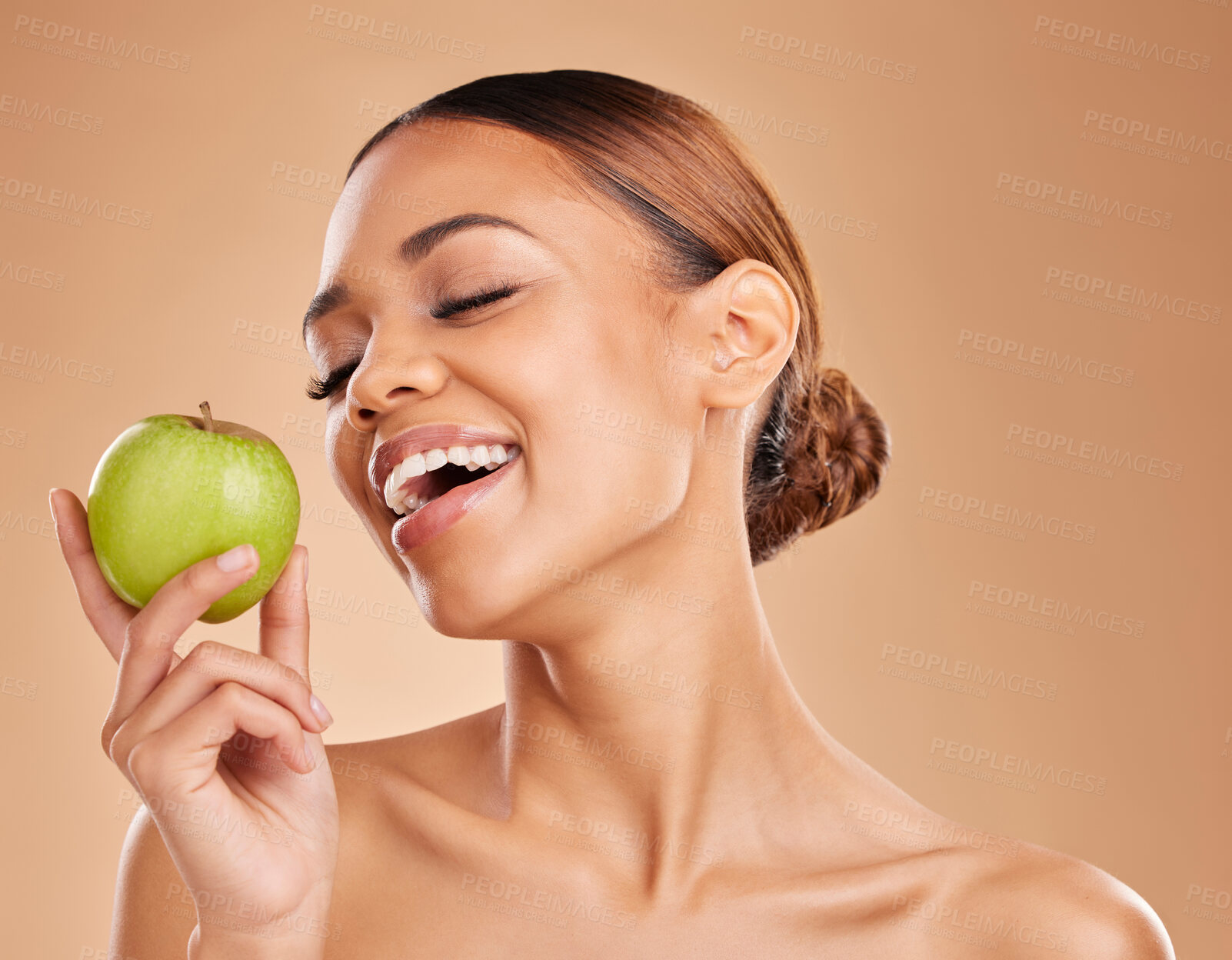 Buy stock photo Beauty, skincare and woman with apple, healthy lifestyle and happiness against a brown studio background. Female, lady and fruit for diet, smile and cosmetics with treatment, smooth and soft skin