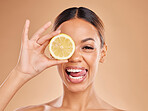Lemon, skincare and face of woman with smile in studio for wellness, facial treatment and natural cosmetics. Beauty, spa aesthetic and happy girl with fruit slice for detox, vitamin c and dermatology
