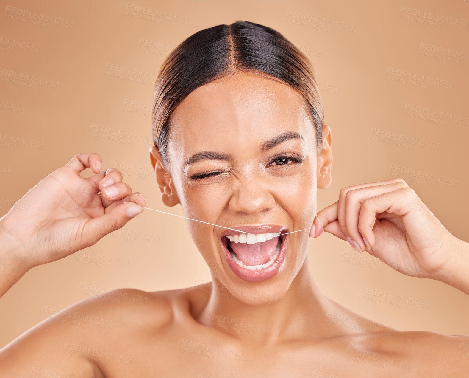 Buy stock photo Portrait, wink and woman flossing in studio for dental, teeth and cleaning against brown background. Face, emoji and floss by girl model with thread for tooth, decay and prevention or oral hygiene