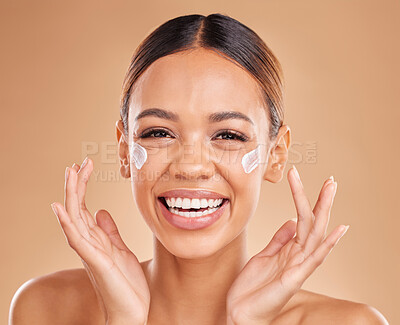 Buy stock photo Face, funny skincare and woman with cream in studio isolated on a brown background. Cosmetics, laughing and portrait of happy female model with lotion, creme or facial moisturizer for skin health.