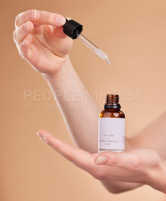 Buy stock photo Hands, serum bottle and pipette for skincare in studio isolated on a brown background. Dermatology product, cosmetics and woman or model with hyaluronic acid, retinol or essential oil for anti aging.